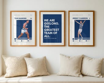 May include: Three framed prints with wooden frames hang on a white wall. The prints feature Geelong football players Tom Hawkins and Jeremy Cameron, and a text-based print that reads "WE ARE GEELONG. THE GREATEST TEAM OF ALL."