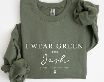 May include: Green sweatshirt with the text "I wear green for Josh Cerebral Palsy Awareness" and a white ribbon.