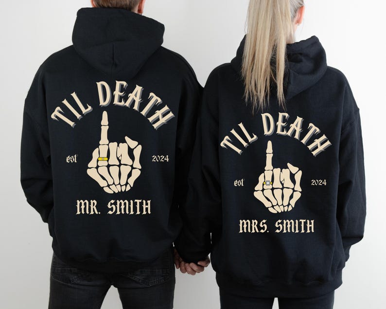 Gothic black hoodies with the text "TIL DEATH" above a skeleton hand giving the middle finger, wearing a ring. The hoodies also read "est 2024" and "MR. SMITH" or "MRS. SMITH".