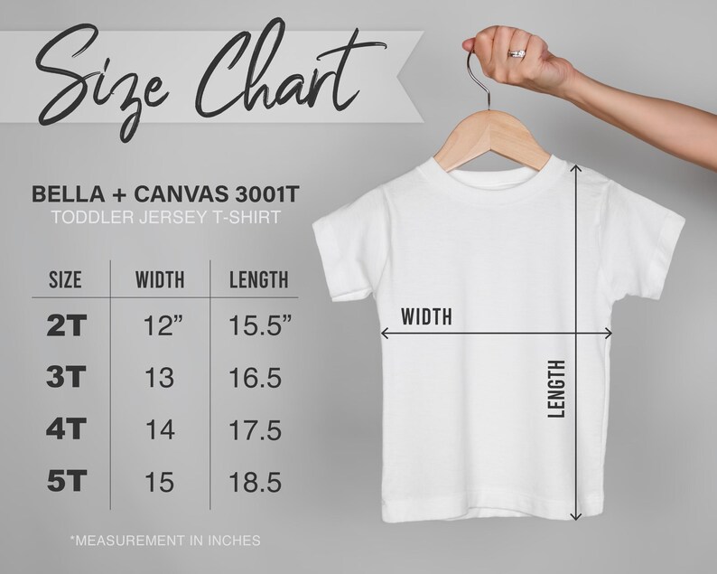 May include: White toddler jersey t-shirt hanging on a wooden hanger. The image includes a size chart with measurements in inches for sizes 2T to 5T. The chart shows the width and length of the shirts. The text on the chart reads "Size Chart" and "BELLA + CANVAS 3001T TODDLER JERSEY T-SHIRT."