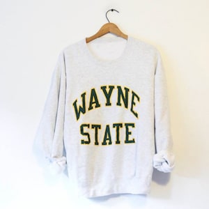 May include: A gray sweatshirt with the text "WAYNE STATE" in green and yellow letters.