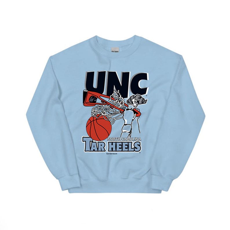 May include: Light blue sweatshirt with a vintage-style graphic of a basketball player dunking. The graphic includes the text "UNC" and "NORTH CAROLINA TAR HEELS".