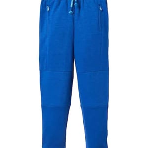 May include: Royal blue sweatpants with a drawstring waist and two zipped pockets. The trousers feature reinforced knee panels and ribbed cuffs at the ankles. These casual trousers are suitable for everyday wear.