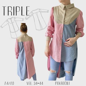 Pode incluir: Uma camisa túnica com blocos de cores e bainha alta-baixa. A camisa apresenta gola e pala bege, mangas rosa e um painel azul tipo ganga. A palavra "TRIPLE" está no topo, com ilustrações de padrões e informações de tamanho.