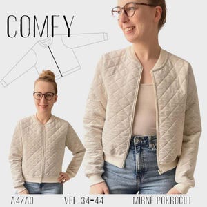Könnte beinhalten: Beige gesteppte Bomberjacke mit Rautenmuster, getragen von einer Person im Bild. Die Jacke hat einen Reißverschluss und gerippte Bündchen und Saum. Das Wort "COMFY" steht oben im Bild, mit dem Text "A4/AO" und "VEL. 34-44" unten.