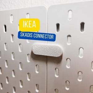 May include: A white ceramic mug with a black handle and the text "But First, Coffee" in a handwritten style. The mug is on a white surface. The mug is 4 inches tall.