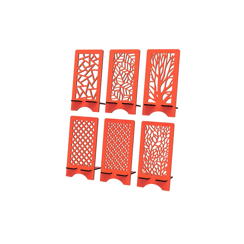 May include: A set of six bright orange rectangular phone stands, each featuring a unique laser-cut pattern. The designs include geometric shapes, leaf motifs, tree branches, a grid pattern, small circular dots, and an intricate floral-like pattern.