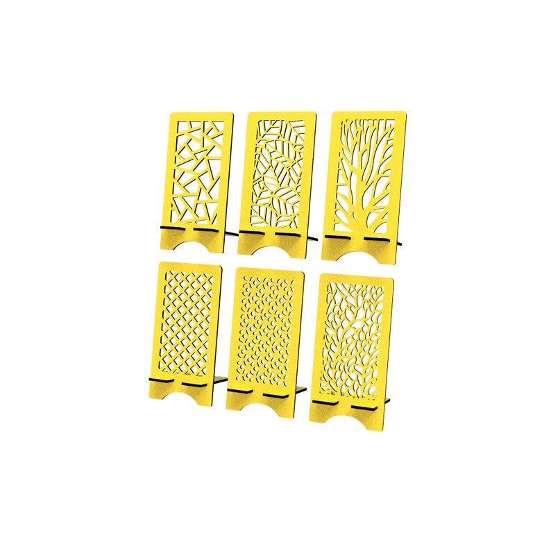 May include: A set of six bright yellow rectangular phone stands, each featuring a unique laser-cut pattern including geometric shapes, leaves, tree branches, a grid, small dots, and organic foliage designs, all with a notched base.