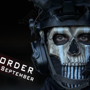 May include: A tactical helmet featuring a realistic skull-patterned face mask with weathered cracks and white vertical stripes. The mask is worn with black communication headsets and a dark neck gaiter. The text PRE-ORDER FOR SEPTEMBER is visible.