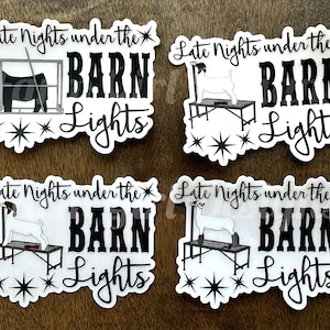 May include: Four white stickers with black text and images. Each sticker says "Late Nights under the BARN Lights" with a starburst design. The images are of a goat or a calf on a show stick.