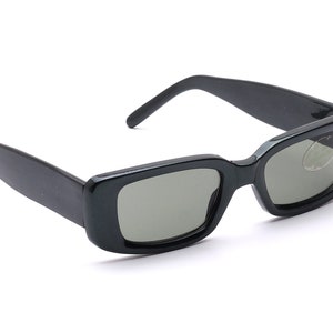 May include: Black rectangular sunglasses with dark gray lenses.
