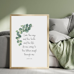 May include: A framed print with a gold-colored frame. The print features the text "I am the way and the truth and the life. No one comes to the Father except through me. JOHN 14:6" with a watercolor eucalyptus branch.