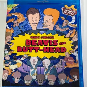 May include: A blue Blu-ray disc case featuring the animated characters Beavis and Butt-Head. The disc cover has a yellow burst with the text "Mike Judge's Beavis and Butt-Head" and various cartoon characters. The "Burger World" logo is visible.