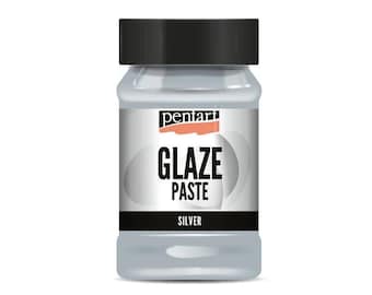 May include: A silver glaze paste in a clear jar with a black lid. The jar has a label that says "Pentart Glaze Paste Silver".