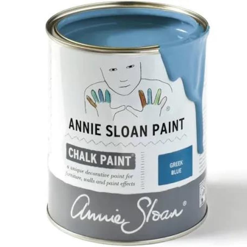 May include: A can of Annie Sloan Chalk Paint in the color Greek Blue. The paint is a unique decorative paint for furniture, walls, and paint effects.