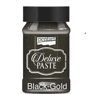 May include: A jar of Pentart Deluxe Paste in Black-Gold. The jar has a black lid and a label with the words "Deluxe PASTE" in a decorative font. The paste inside appears to be black with gold flecks.