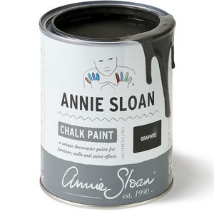 May include: A can of Annie Sloan Chalk Paint in the color Graphite. The can is white with black text and a black and white illustration of hands. The can is partially open and the paint is dripping down the side.