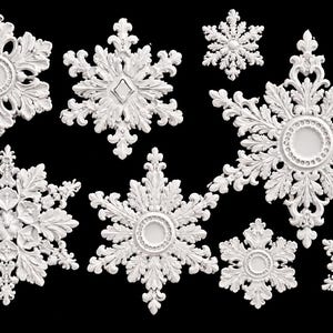 May include: A collection of eight white, ornate snowflake-shaped decorations featuring intricate filigree, leaf-like patterns, and central circular or diamond-shaped motifs. These decorative pieces are arranged against a solid black background.