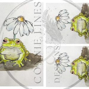 May include: A watercolor painting of a green frog with a white daisy on its head. The frog is sitting on a brown surface. The painting is done in a whimsical style.