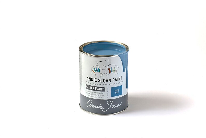 May include: A can of Annie Sloan Chalk Paint in the color Green Blue. The can is open and the paint is visible inside. The can is labeled with the Annie Sloan logo and the name of the color.