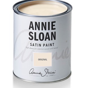 May include: A white paint can with the text "Annie Sloan Satin Paint" and "Original" on the label. The paint is for interior wood and metal.
