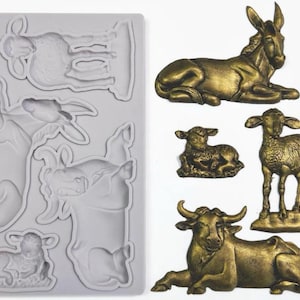 May include: A gray silicone mold with animal shapes, including a lamb, cow, and donkey. Next to the mold are gold-colored resin animal figurines: a donkey, two lambs, and a cow. The figurines are detailed and textured.