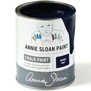 May include: A can of Annie Sloan Chalk Paint in the color Oxford Navy. The can is white with a handprint design and the text "Annie Sloan Paint" and "Chalk Paint".