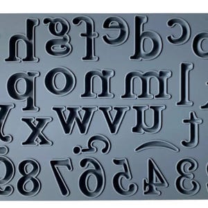 May include: A gray silicone mold with letters and numbers for baking or crafting. The mold includes the alphabet in uppercase and the numbers 1 through 9 and 0.