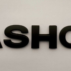 May include: Black plastic letters spelling out the word "QASHQAI".