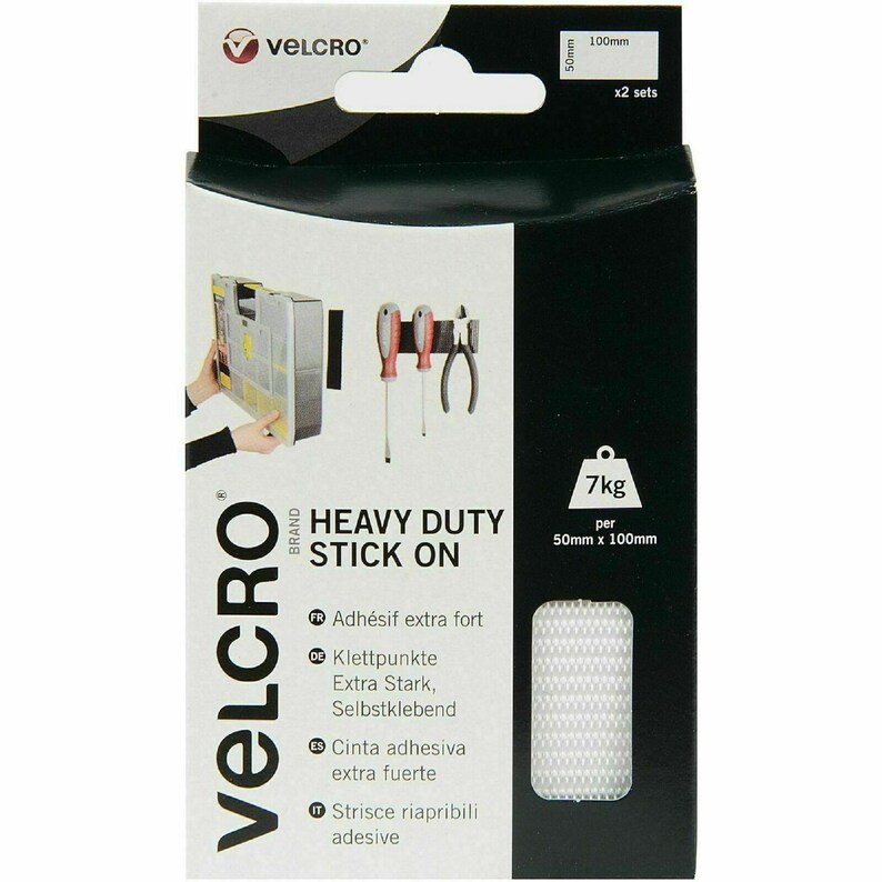 May include: A package of VELCRO&reg; Brand Heavy Duty Stick On fasteners. The package shows a black strip of the fastener holding up tools on a metal surface. The package includes two sets of 2 inch by 4 inch fasteners. The package also shows a 7kg weight to indicate the holding strength of the fasteners.