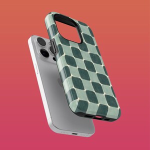 May include: A green and white checkered phone case for an iPhone.
