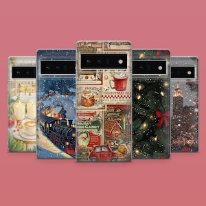 May include: A collection of phone cases with Christmas-themed designs. The cases feature images of a train, a Christmas tree, a gingerbread house, and a mug of hot chocolate. The cases are arranged in a row against a pink background.