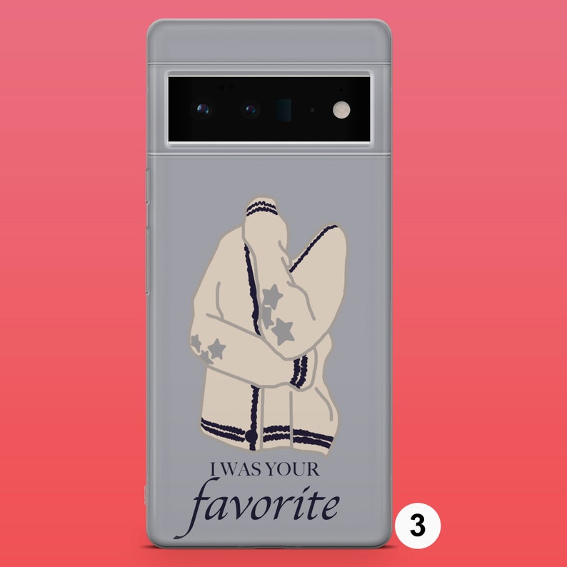 May include: A grey phone case with a white sweater with stars and the text "I was your favourite" in black.
