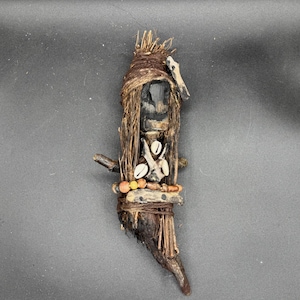 May include: A white ceramic mug with a black handle and the text "But First, Coffee" in a black, handwritten-style font. The mug is on a white surface.