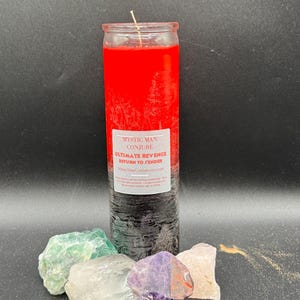 May include: A layered candle with a red top and black base, labelled "Mystic Man Conjure: Ultimate Revenge Return to Sender." The candle is surrounded by various colourful crystals, including green, white, and purple stones.