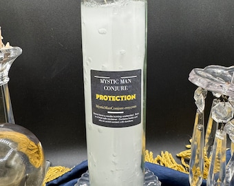 May include: White candle in a glass jar with a black label that reads "Mystic Man Conjure Protection" and a website address. The candle is on a clear glass base.