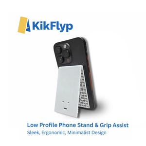 May include: A black smartphone is propped up by a white, low-profile phone stand and grip assist. The stand has a minimalist design and features the text "Low Profile Phone Stand & Grip Assist. Sleek, Ergonomic, Minimalist Design."