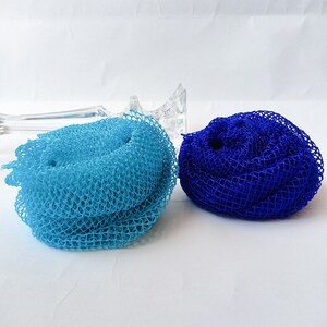 May include: Two bath poufs, one blue and one light blue, made of a soft, mesh material.