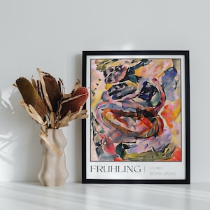 May include: A framed abstract art print featuring a colourful, swirling design in shades of pink, yellow, blue, and red. The print is titled "FR&Uuml;HLING" with the artist's name and date "CLARA | BONN 2021" below the title.