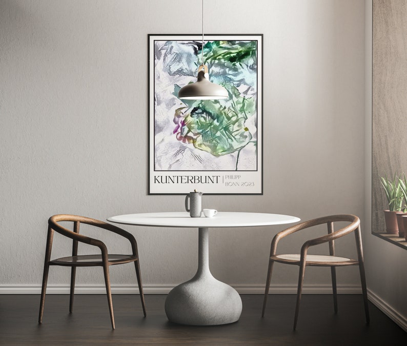 May include: A white table with a round top and a grey base sits in a room with two wooden chairs. A white pendant light hangs above the table. A framed poster with a colourful abstract design hangs on the wall behind the table. The poster has the text "Kunterbunt | Philipp Joan 2023".