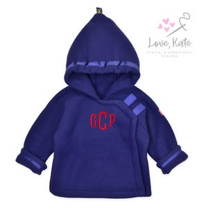 May include: A purple fleece hooded jacket with a blue trim and a red embroidered monogram "GCP".