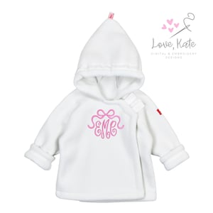 May include: White hooded baby jacket with a pink embroidered monogram "EME" on the front. The jacket has a zipper closure and a hood with a white lining.
