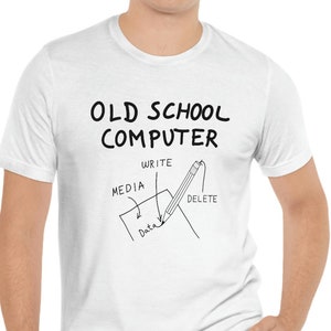 May include: White t-shirt with a black graphic that says "Old School Computer" and depicts a pencil writing on a piece of paper with the words "Write", "Media", "Data", and "Delete" around it.
