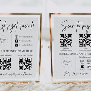 May include: A white sign with black text and graphics. The sign says "Let's get social!" and includes a logo, social media handles, and QR codes for visiting a website and leaving a review. The sign also says "Thank you for supporting our small business!"