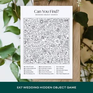 May include: A black and white wedding object search game printed on a 5x7 inch card. The card features a detailed illustration of wedding-themed objects, including a cake, hearts, and a church. The text "Can You Find?" is at the top.
