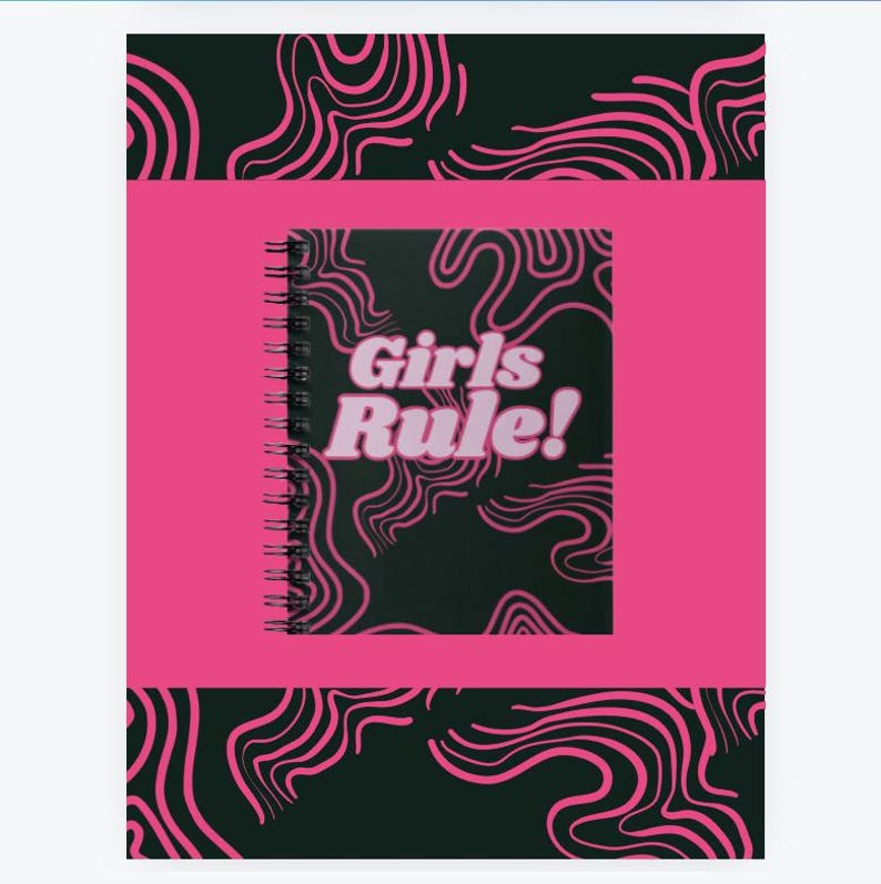 May include: A pink and black spiral notebook with a black cover featuring pink swirling lines and the text "Girls Rule!" in pink letters.
