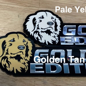 May include: Two black and silver car emblems with a golden retriever dog silhouette. The top emblem has a white dog and the text "GOLDEN EDITION". The bottom emblem has a tan dog and the text "GOLDEN EDITION".