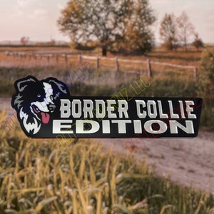 May include: Black and silver car emblem with a white and black border collie dog head and the text "BORDER COLLIE EDITION".