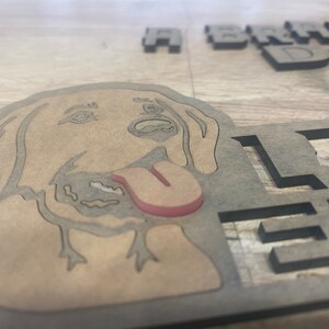 May include: A wooden sign with a cutout of a dog's head and the text "A Brand New Dog Life" in black lettering.