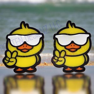 May include: Two yellow rubber duckies wearing sunglasses and giving the peace sign. The duckies are cartoon-style and have black outlines. The background is a blurry image of a beach.
